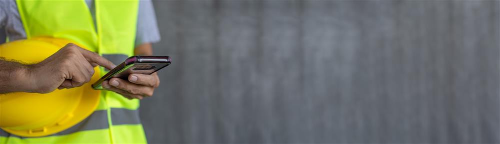 Construction worker holding phone